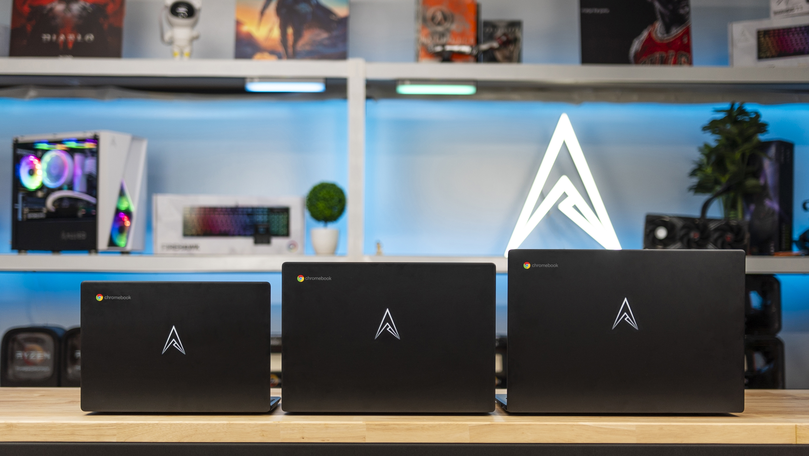Three Allied Chromebooks lined up in front of the illuminated Allied logo