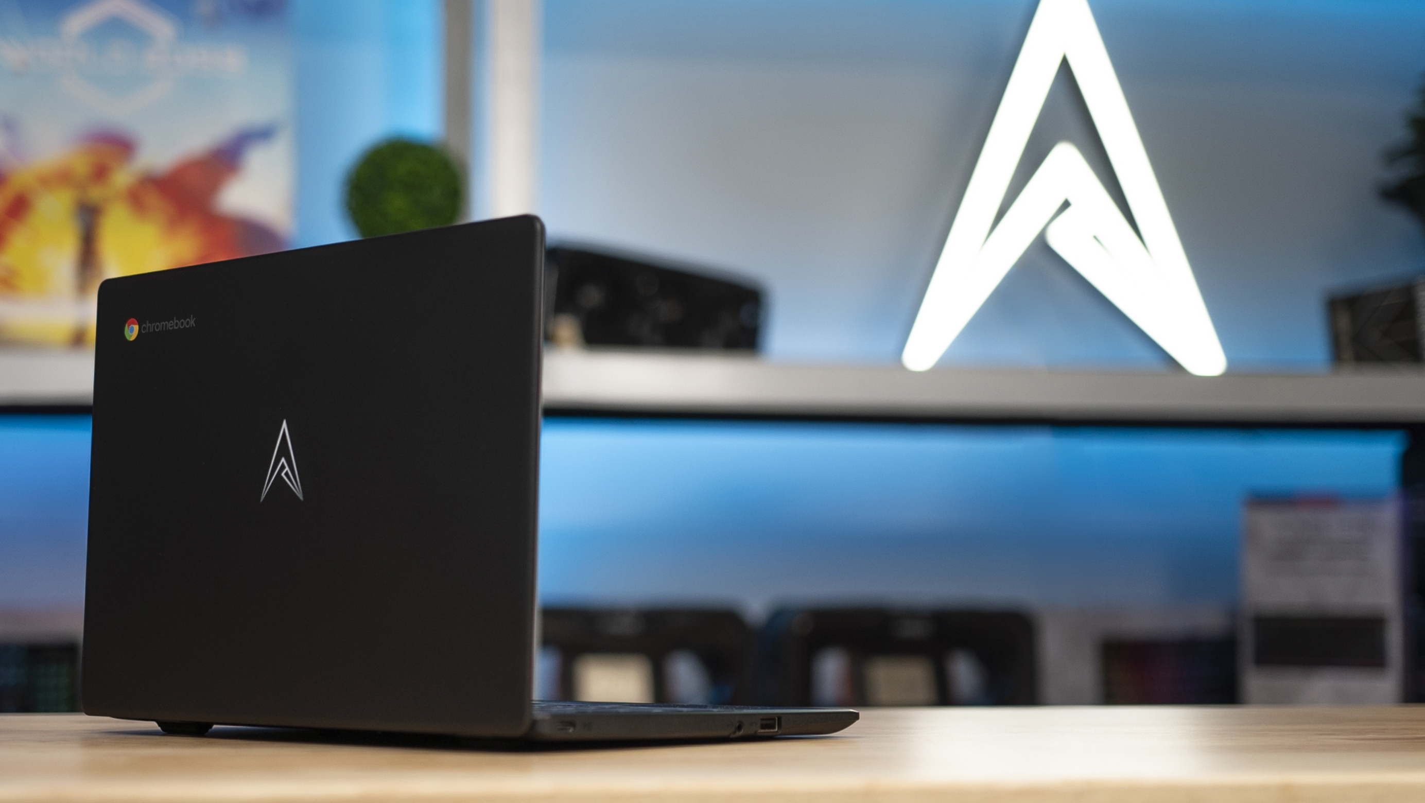 Allied Chromebook lid in front of the illuminated Allied logo